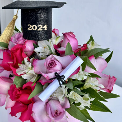 The perfect box that will carry the name of your graduate! Roses in shades of pink, white and pink astromelias with small touches of pink ornamentation. Accompanied by a grad cap and a diploma