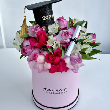 The perfect box that will carry the name of your graduate! Roses in shades of pink, white and pink astromelias with small touches of pink ornamentation. Accompanied by a grad cap and a diploma