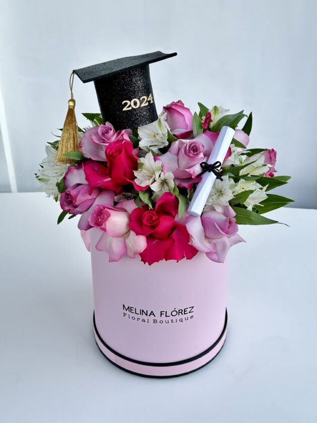 The perfect box that will carry the name of your graduate! Roses in shades of pink, white and pink astromelias with small touches of pink ornamentation. Accompanied by a grad cap and a diploma